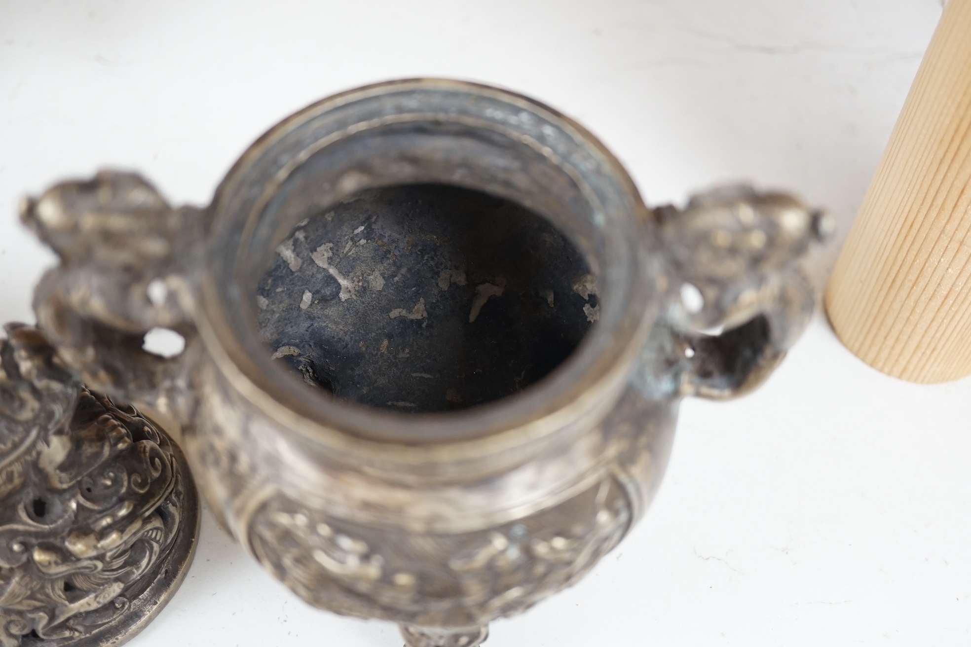 A Chinese silvered bronze lidded ‘dragon’ censer, 16cm tall. Condition - fair to good